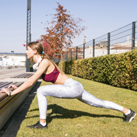 /young-woman-sportswear-stretching-her-leg-outdoor-5-minutes-workout